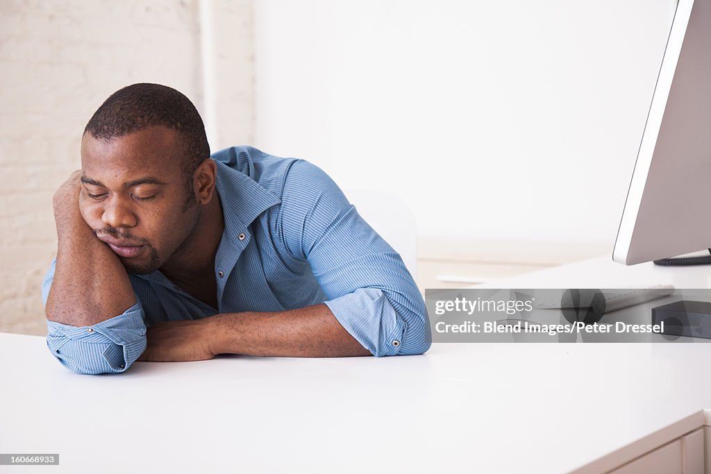 Black businessman sleeping at desk