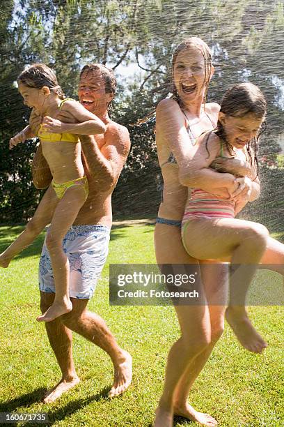 family at home playing in garden - shower man woman washing stock pictures, royalty-free photos & images