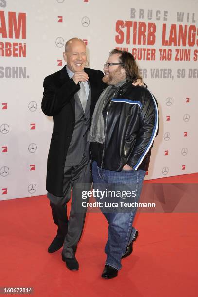 John Moore and Bruce Willis attend the premiere of 'Die Hard - Ein Guter Tag Zum Sterben' at Sony Center on February 4, 2013 in Berlin, Germany.