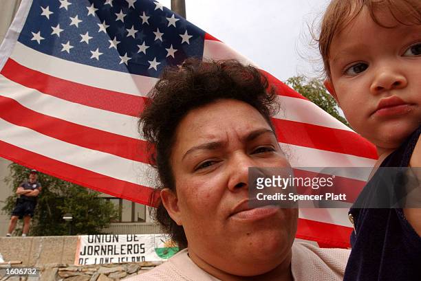 Maria Romero and her daughter Janci attend a rally against anti-Mexican racism August 3, 2001 near the town of Farmingville, New York. Many residents...