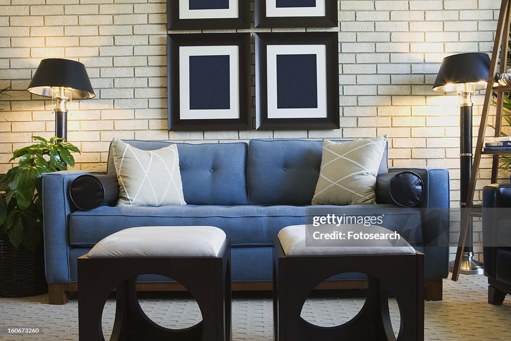 Detail of living room couch with foot stools