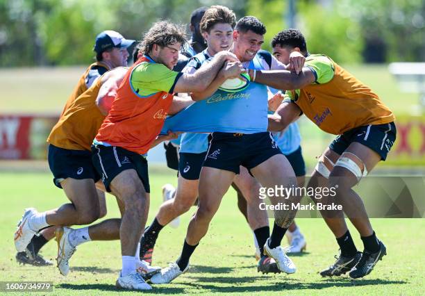 Izaia Perese of the Wallabies tackled by Fraser McReight of the Wallabies and Langi Gleeson of the Wallabies during the Australia Wallabies training...