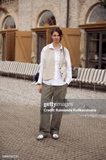 Jacqueline Zelwis wears a vest, a white shirt and army green pants with side pockets outside Munthe during the Copenhagen Fashion Week Spring/Summer...