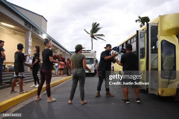 Volunteers with King's Cathedral Maui unload donations of blankets and supplies on August 10, 2023 in Kahului, Hawaii. Dozens of people were killed...