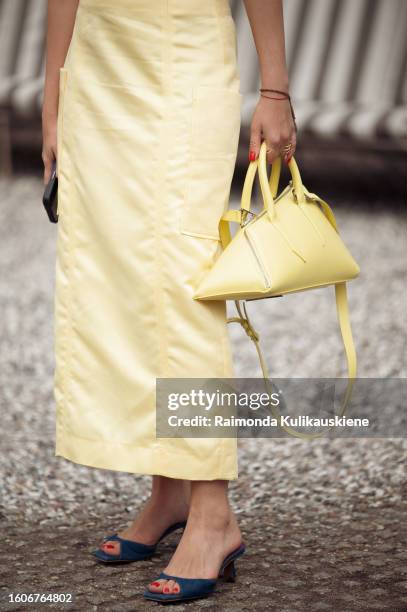 Guest wears a yellow skirt and yellow bag outside Munthe during the Copenhagen Fashion Week Spring/Summer 2024 on August 10, 2023 in Copenhagen,...