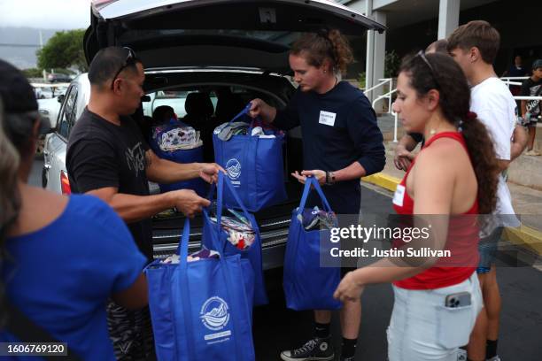 Volunteers with King's Cathedral Maui help unload a donation of supplies on August 10, 2023 in Kahului, Hawaii. Dozens of people were killed and...