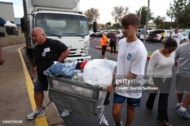 Volunteers with King's Cathedral Maui unload a donation of clothing on August 10, 2023 in Kahului, Hawaii. Dozens of people were killed and thousands...