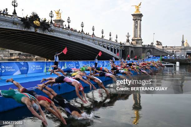 Triathlon athletes dive in the Seine river during the men's 2023 World Triathlon Olympic Games Test Event in Paris, on August 18, 2023. From August...