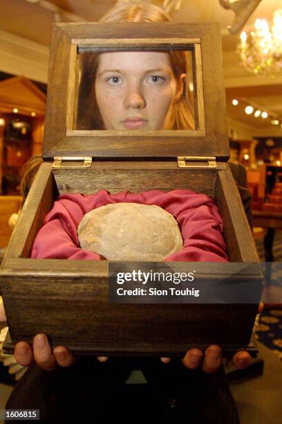 Marketing officer Alison Driver holds a Therizinosaur egg August 3, 2001 at the Fortnum and Mason''s exclusive department store in London, United...