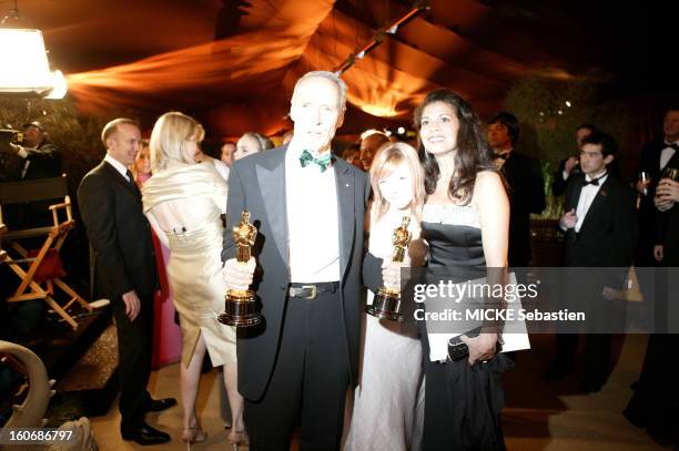 Clint Eastwood taking his two Oscars for best director and best film 'Million Dollar Baby' to the dimensions of his wife Dina Ruiz and their daughter...