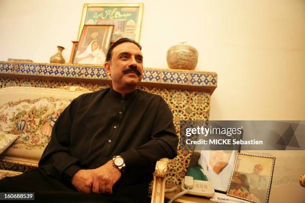 Plan three quarters Asif Ali Zardari smiling sitting in a lounge of the PPP in Larkana, a framed portrait of his wife Benazir Bhutto has raised its...