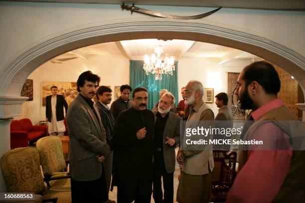 Asif Ali Zardari posing in a living room of the PPP in Larkana, surrounded by party members, four days after the death of his wife Benazir Bhutto.