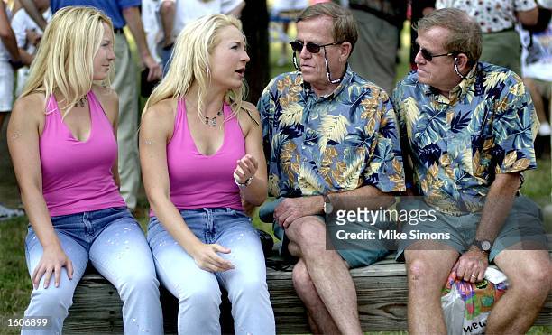 Two pairs of twins talk during the Twinsburg Twins Days Festival August 3, 2001 in Twinsburg, Ohio.