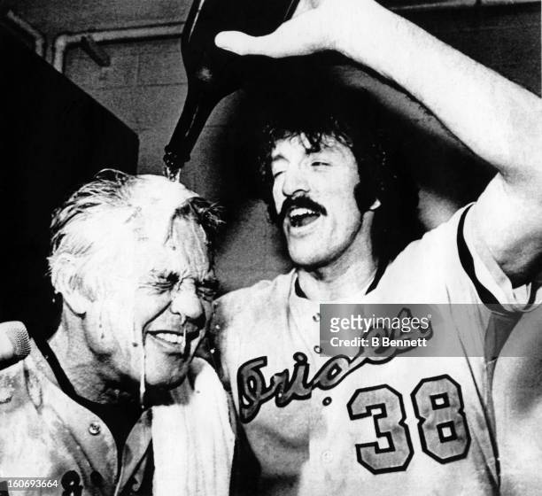 John Lowenstein of the Baltimore Orioles pours champagne over manager Earl Weaver's head after the Orioles defeated the California Angels in Game 4...