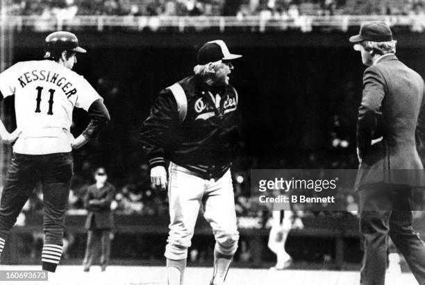 Manager Earl Weaver of the Baltimore Orioles argues with umpire Larry Barnett as manager/player Don Kessinger of the Chicago White Sox looks on after...