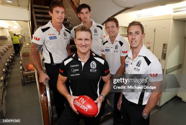 Dayne Beams,Scott Pendlebury, Luke Ball and captain Nick Maxwell stand with coach Nathan Buckley in the cabin of an Emirates A380 aircraft after the...