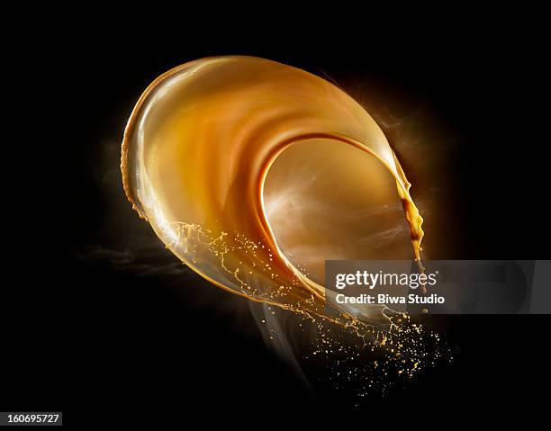 coffee splash in midair on black background - coffee background stock pictures, royalty-free photos & images