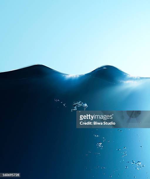 water surface, water wave and bubbles - water surface stock pictures, royalty-free photos & images
