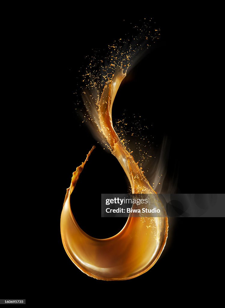 Coffee splash in midair on black background