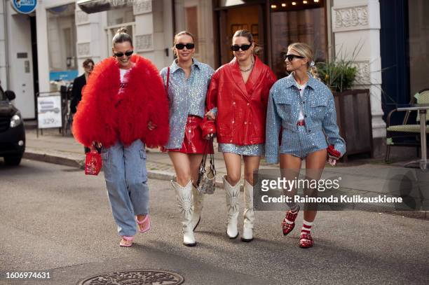 Guests dressed up in red, blue, and white outfits walk outside Rotate during the Copenhagen Fashion Week Spring/Summer 2024 on August 10, 2023 in...