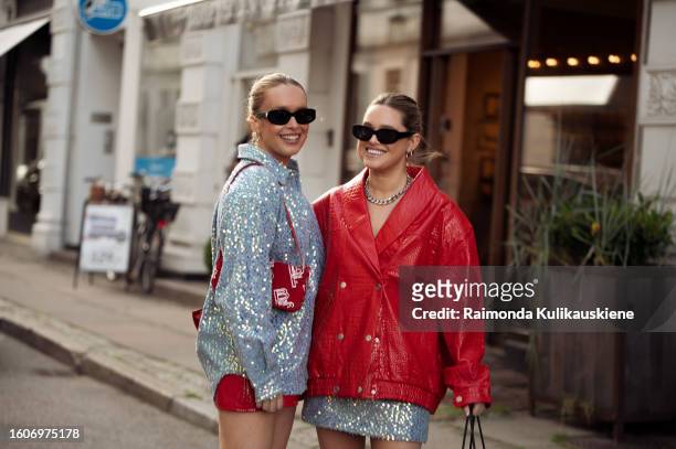 Guest wears red mini skirt, blue shirt, red bag and white long cowboy shoes and a guest wears blue miniskirt, red lether jacket silver metal Loewe...