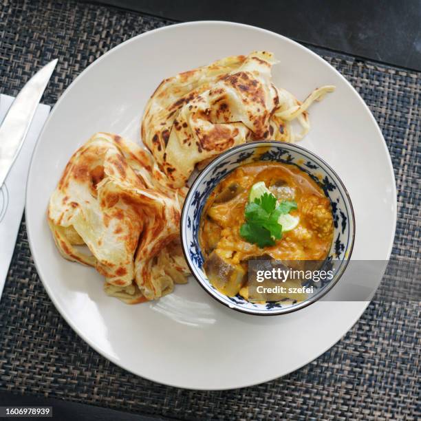 malaysian cuisine roti canai, indian food with vegetable curry sauce - serving dish stock pictures, royalty-free photos & images