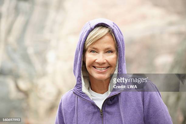 mature woman in purple hoodie - woman 50s blue eyes stock pictures, royalty-free photos & images