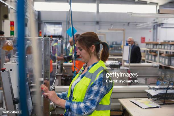 young women working on the production line in factory - garment factory stock pictures, royalty-free photos & images