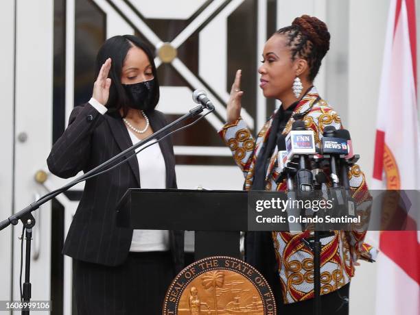 Aramis Ayala, left, swears in Monique Worrell as the new State Attorney of the Ninth Judicial Circuit during a ceremony at Orlando City Hall on...