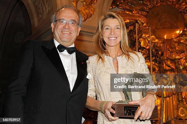 Professor David Khayat and sculptor Helene Jousse, who sculpted the award she holds, pose after Jousse received the Special Prize of the Paris...