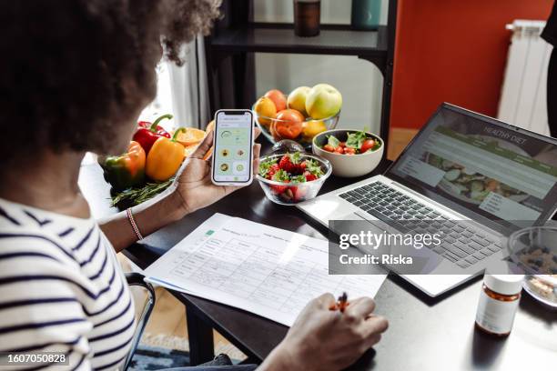a female dietitian preparing a meal plan - healthy food stock pictures, royalty-free photos & images