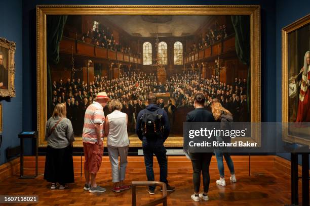 Visitors to the recently-renovated National Portrait Gallery view 'The House of Commons, 1833' by Sir George Hayter, on 13th August 2023, in London,...