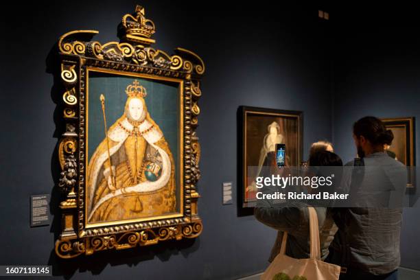 Visitor to the Tudors section of the recently-renovated National Portrait Gallery takes a photo of a portrait of Queen Elizabeth I by an unknown...