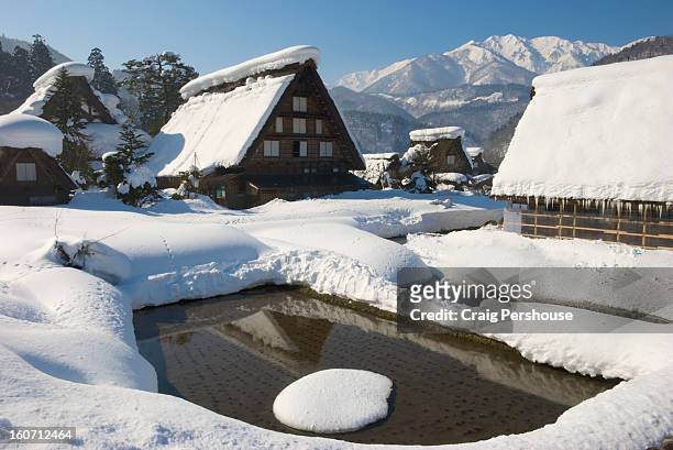 unfrozen rice paddy and gassho-zukuri houses - unfrozen stock pictures, royalty-free photos & images