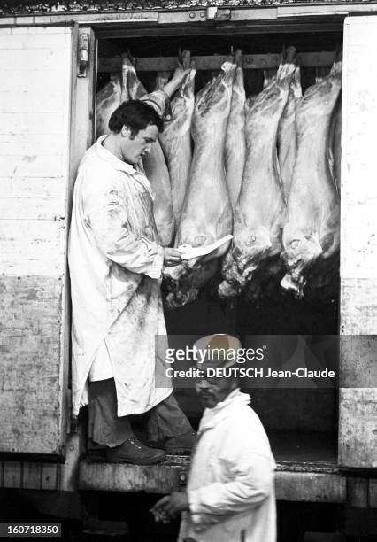 The Halls Of Rungis The Meat Market. Val-de-Marne, Rungis- 22 Avril 1975- Reportage sur les Halles de Rungis et son marché de la viande: un boucher...