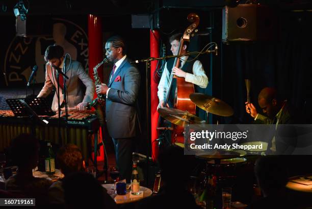 Lewis Wright, Tom Farmer, Nathaniel Facey and Shane Forbes of the band Empirical perform on stage at Pizza Express Jazz Club on February 4, 2013 in...