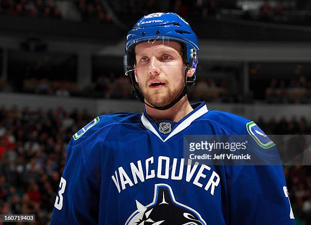 Alexander Edler of the Vancouver Canucks looks on from the bench during their NHL game against the Colorado Avalanche at Rogers Arena January 30,...