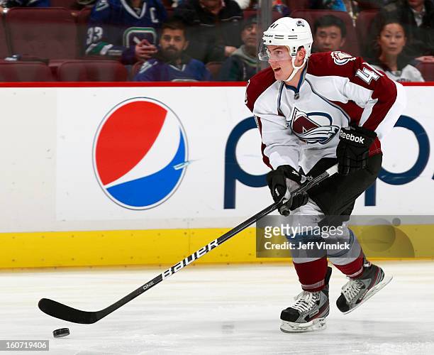 Tyson Barrie of the Colorado Avalanche skates up ice with the puck during their NHL game against the Vancouver Canucks at Rogers Arena January 30,...