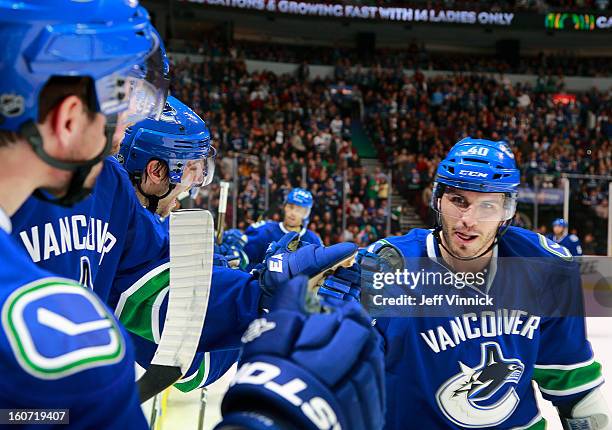 Maxim Lapierre of the Vancouver Canucks is congratulated by teammates after scoring their NHL game against the Colorado Avalanche at Rogers Arena...