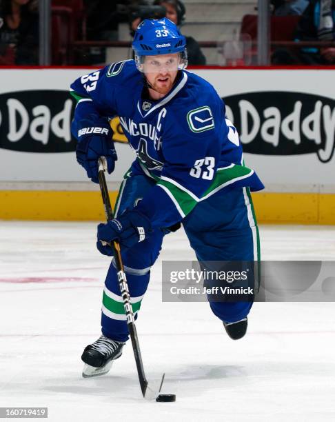 Henrik Sedin of the Vancouver Canucks skates up ice with the puck during their NHL game against the Colorado Avalanche at Rogers Arena January 30,...