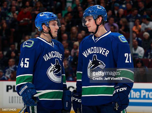 Mason Raymond of the Vancouver Canucks talks to teammate Jordan Schroeder during their NHL game against the Colorado Avalanche at Rogers Arena...