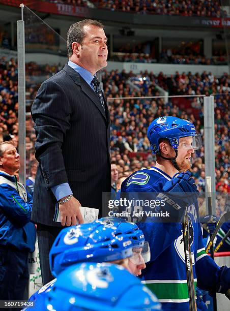 Head coach Alain Vigneault of the Vancouver Canucks looks on from the bench during their NHL game against the Colorado Avalanche at Rogers Arena...