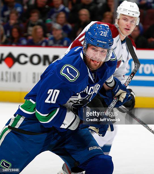 Chris Higgins of the Vancouver Canucks and Jamie McGinn of the Colorado Avalanche skate up ice during their NHL game at Rogers Arena January 30, 2013...