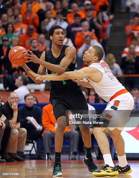 Cameron Biedscheid of the Notre Dame Fighting Irish attempts to pass the ball against Brandon Triche of the Syracuse Orange during the game at the...
