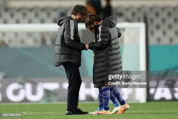 Moeka Minami and Fuka Nagano of Japan are consoled by head coach Futoshi Ikeda after the team's 1-2 defeat and elimination from the tournament...