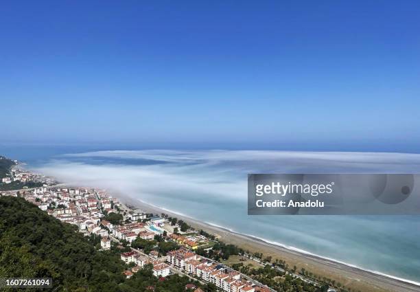 An aerial view of fog blankets over a beach and sea during foggy weather in Abana district of Kastamonu, Turkiye on August 18, 2023. The fog called...