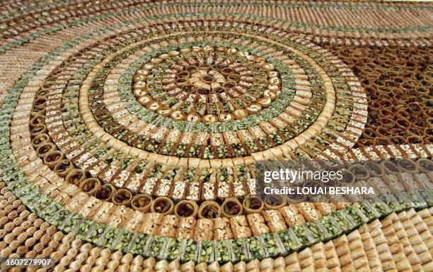 Picture shows part of a mosaic of traditional Arabic sweets, measuring 112 meters long, which entered the Guiness Book of World Records as the...