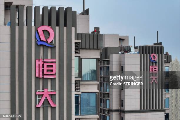 The Evergrande logo is seen on residential buildings in Nanjing, in China's eastern Jiangsu province on August 18, 2023. Embattled Chinese property...