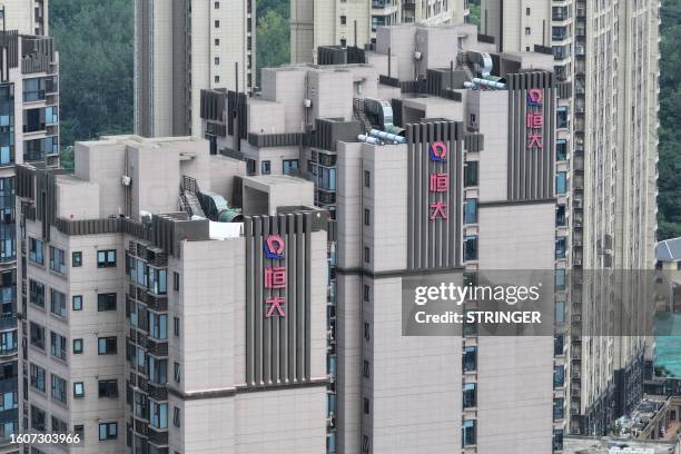 The Evergrande logo is seen on residential buildings in Nanjing, in China's eastern Jiangsu province on August 18, 2023. Embattled Chinese property...