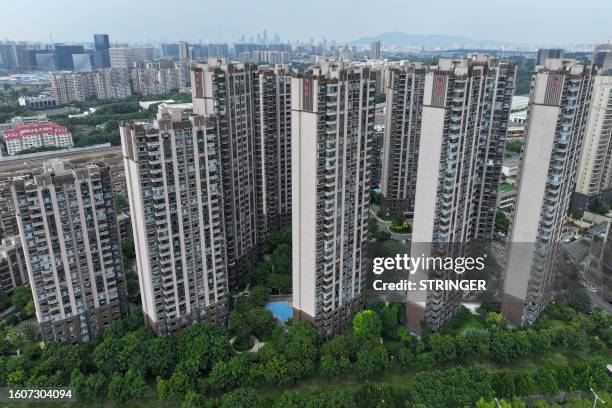 The Evergrande logo is seen on residential buildings in Nanjing, in China's eastern Jiangsu province on August 18, 2023. Embattled Chinese property...